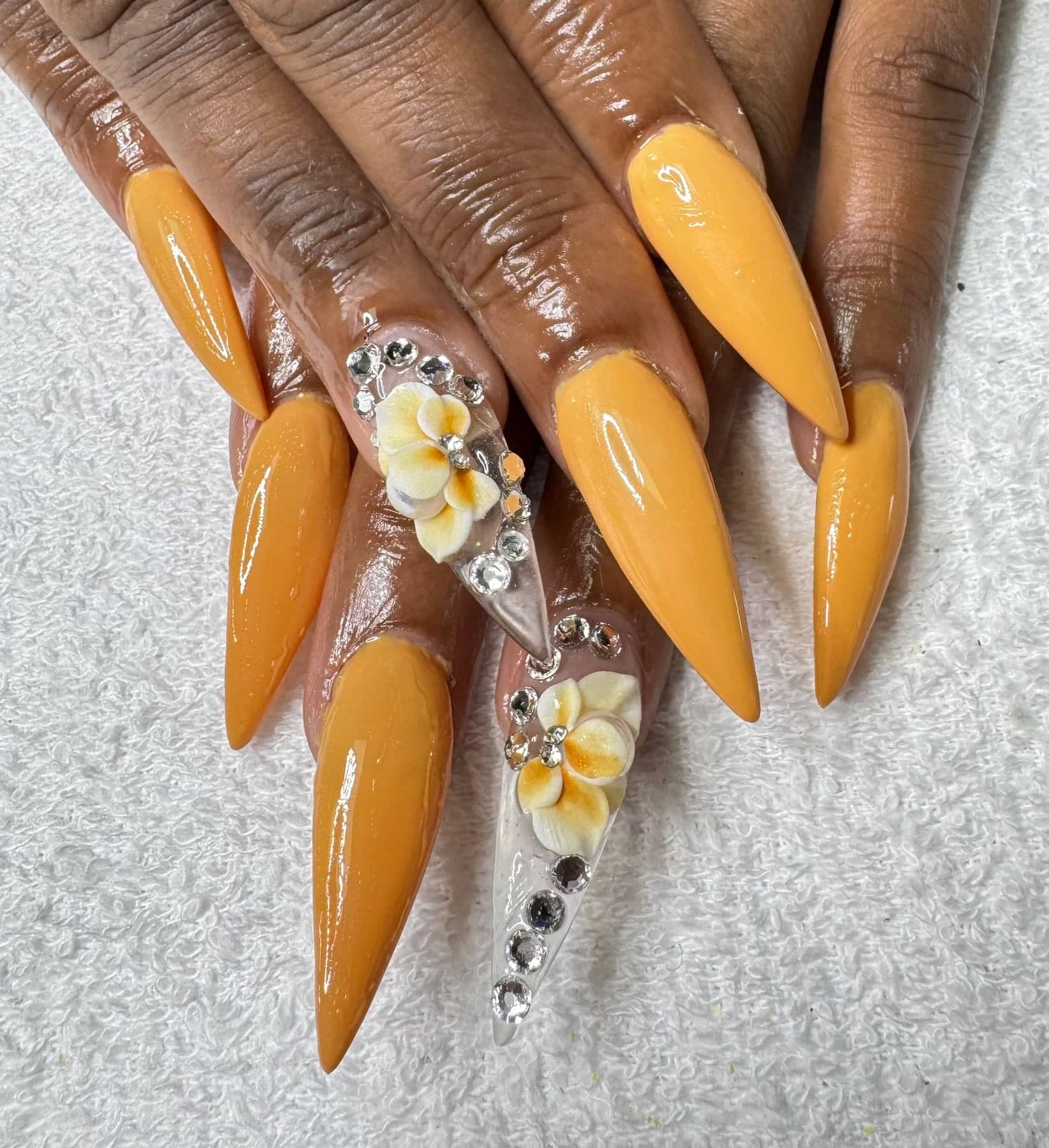 Amber stiletto nails with 3D flowers and crystals